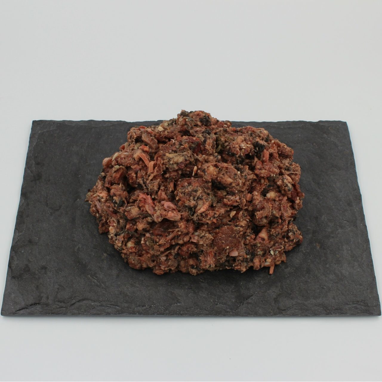A patty of Beef Complete Mix all-natural raw dog food from Raw K9